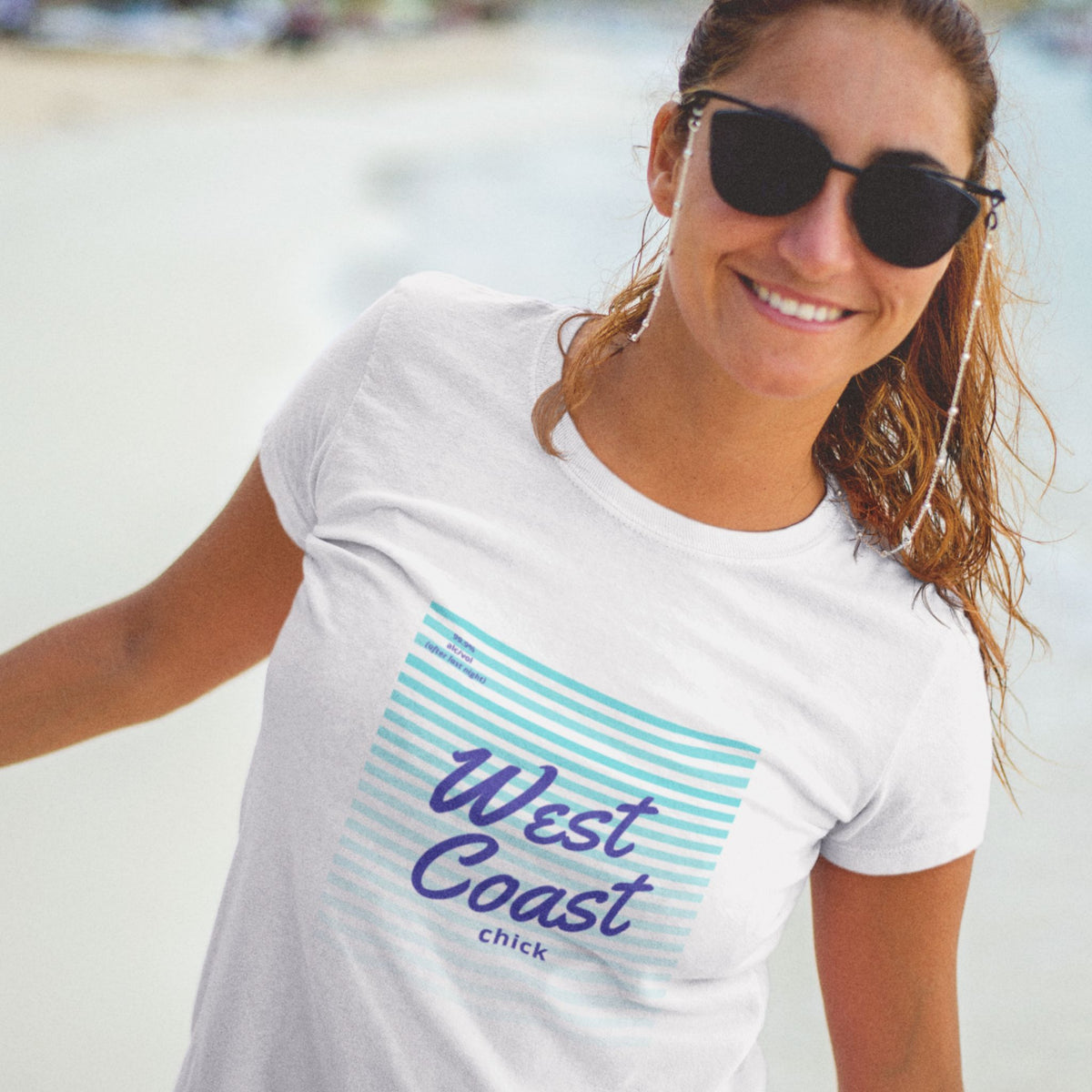Woman wearing white t shirt with West Coast chick design on front