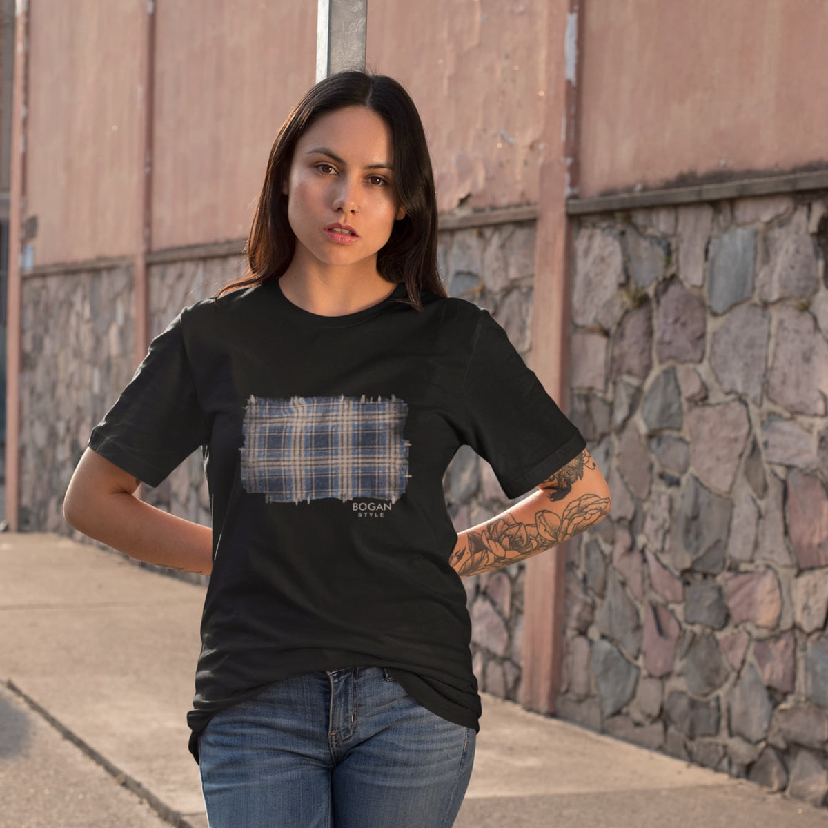 woman wearing black t shirt with bogan style black flanno design on front. relaxed fit