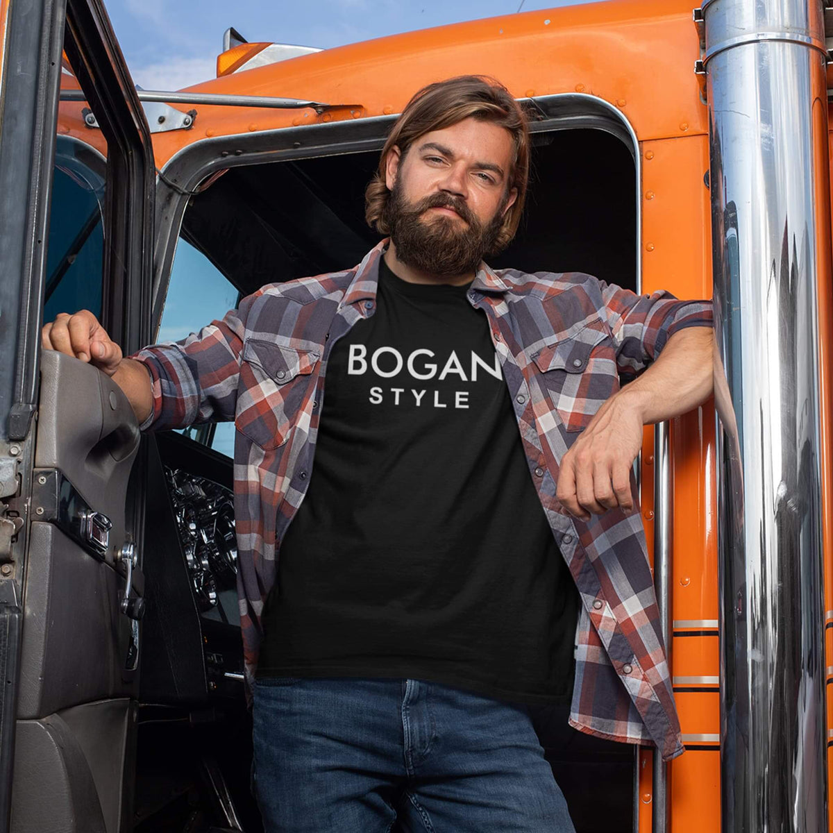 Truckie wearing a flanno shirt and black t shirt with Bogan Style printed on the front