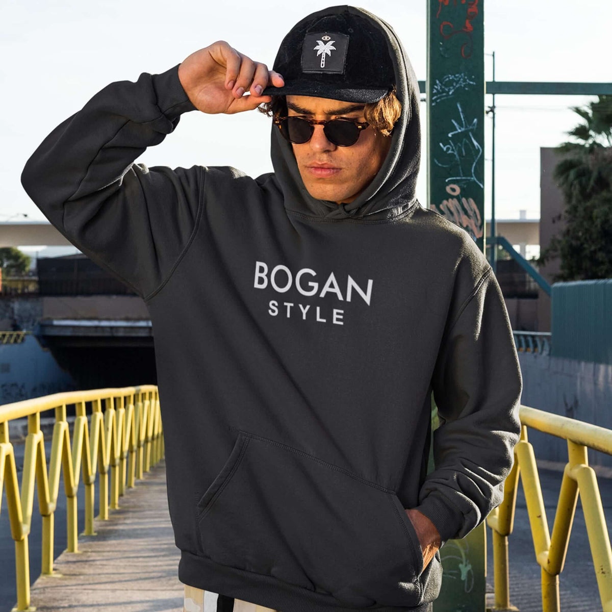 Man wearing black hoodie with Bogan Style printed on the front. 