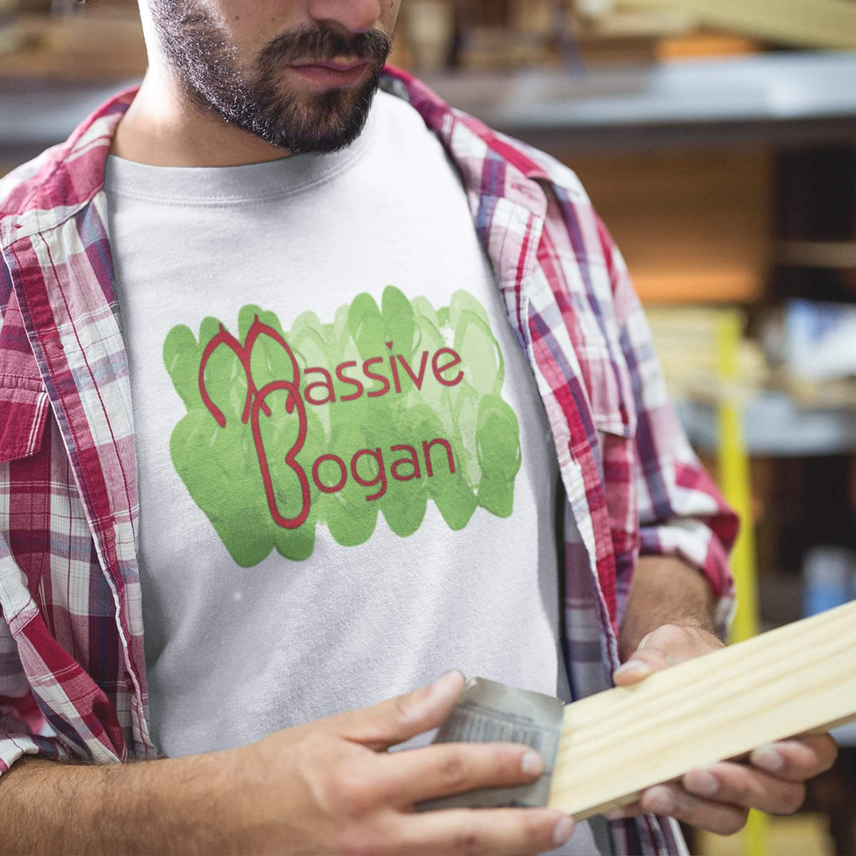 Man wears Massive Bogan design on white tee under flanno shirt