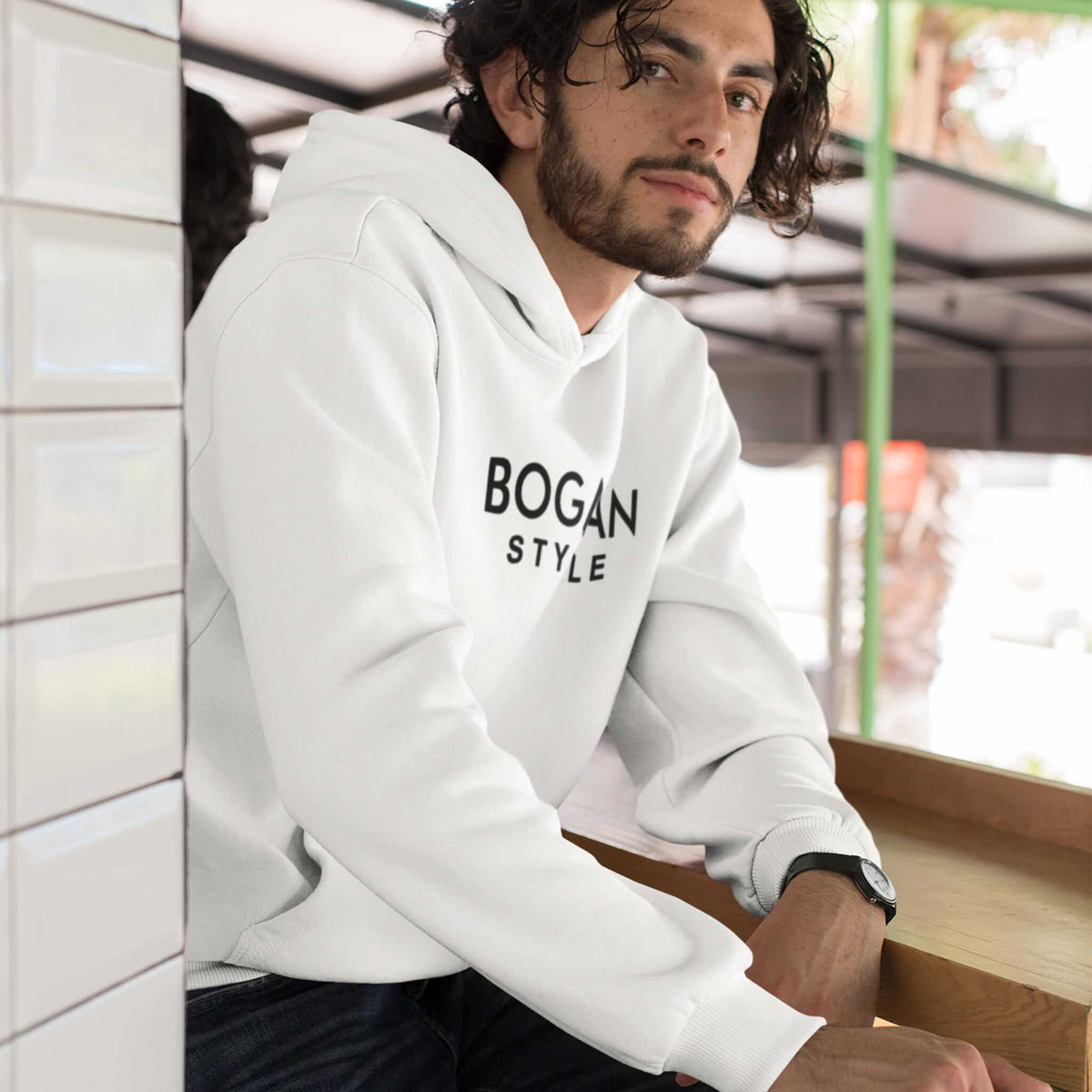 Man wearing white hoodie with Bogan Style printed on the front