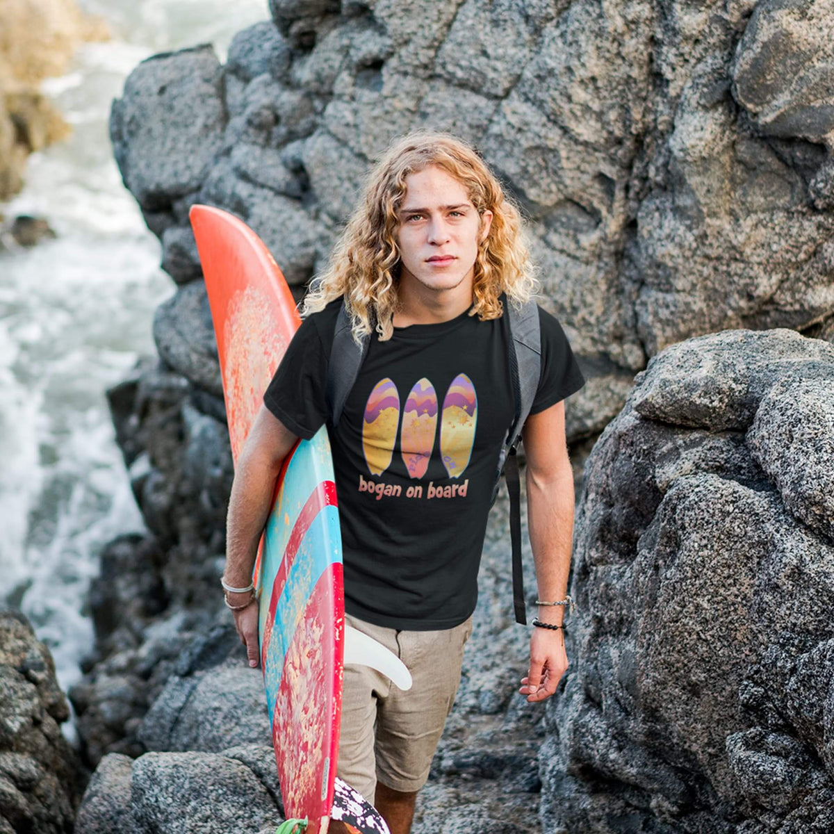 Surfer wearing black tee with Bogan on Board graphic surf design
