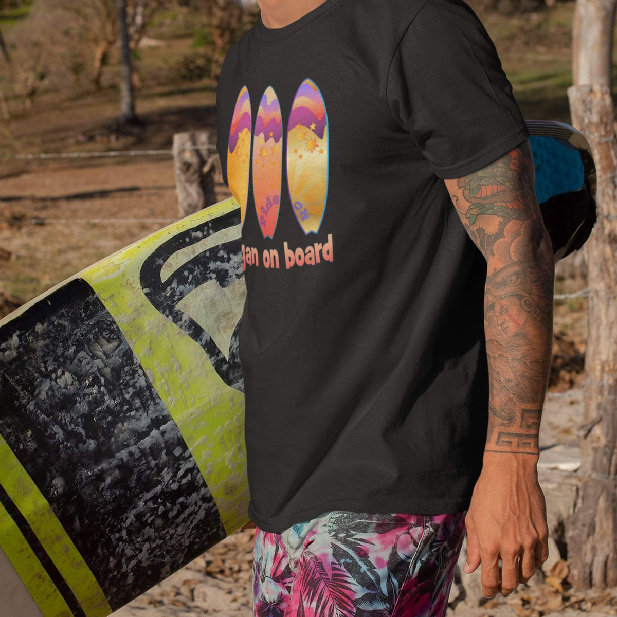 surfer wears black tee with Bogan on Board graphic design
