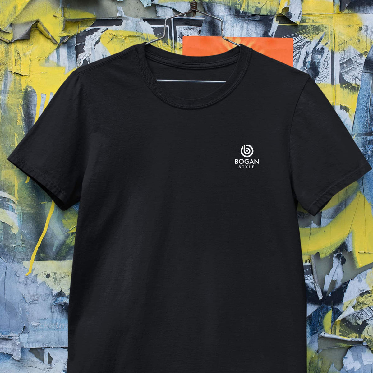 Men's black t shirt on graffiti background wth small white logo